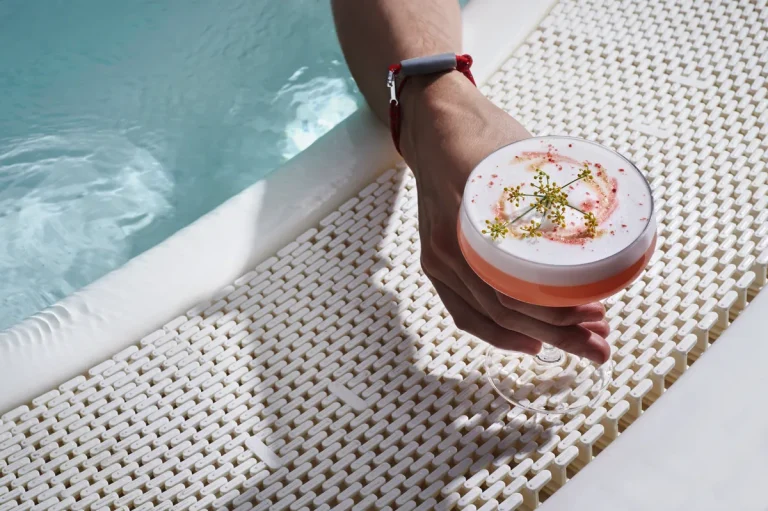 Poolside cocktails at the Sun Club on a Virgin Voyages ship, the kind of onboard spending a $300 bar tab perk covers